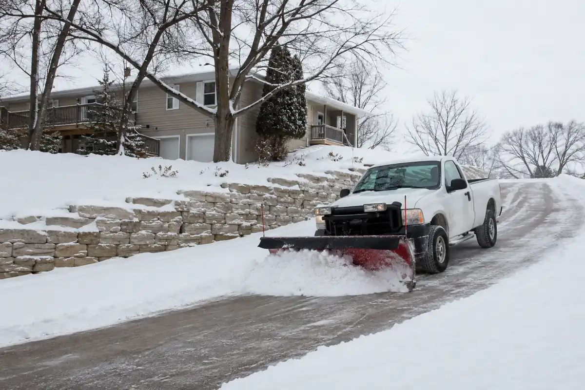 North Mankato Lawn Care plowing a snowy driveway